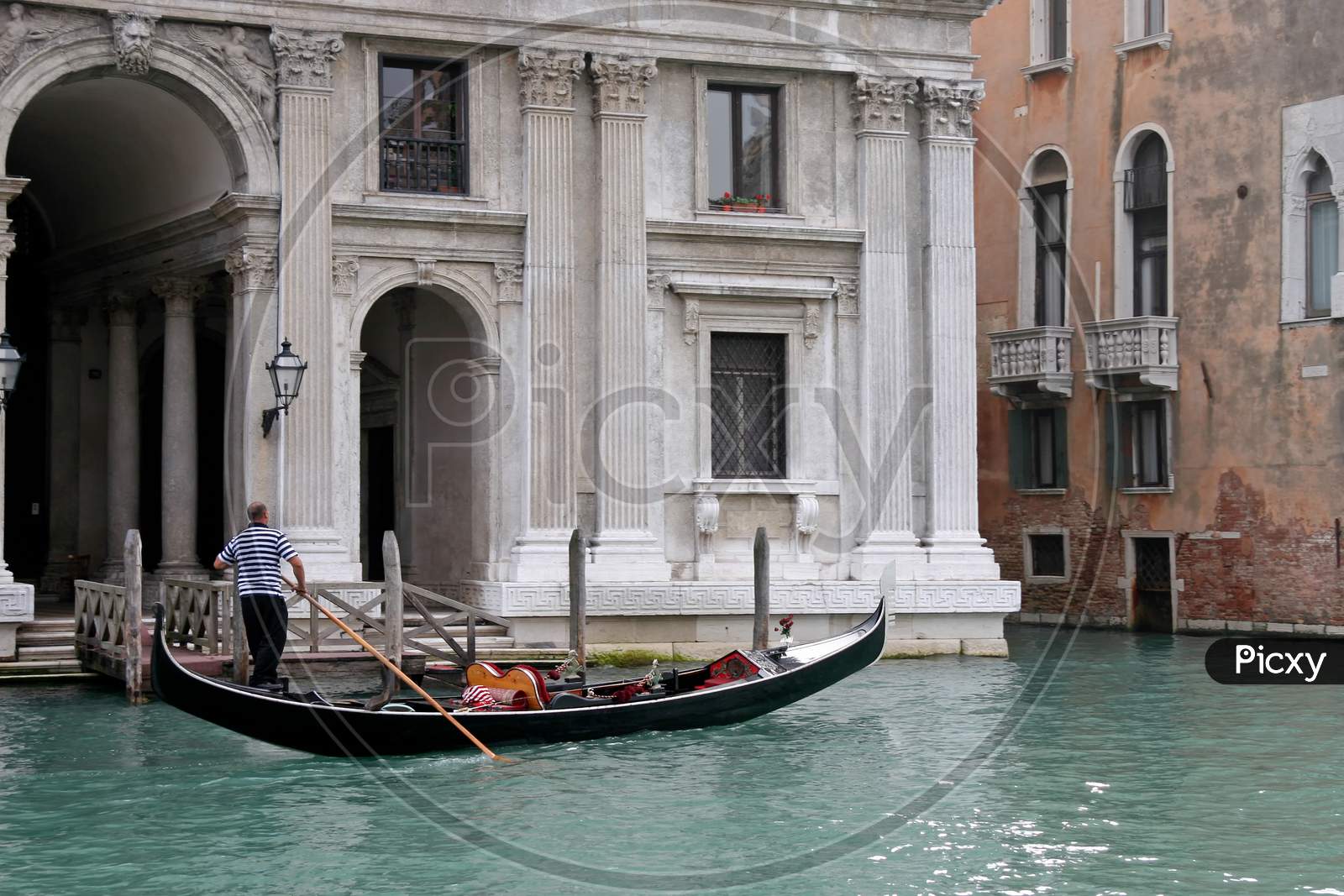 Venice, Italy - October 26 : Gondolier Rowing Along A Canal In Venice On October 26, 2006. Unidentified Man.