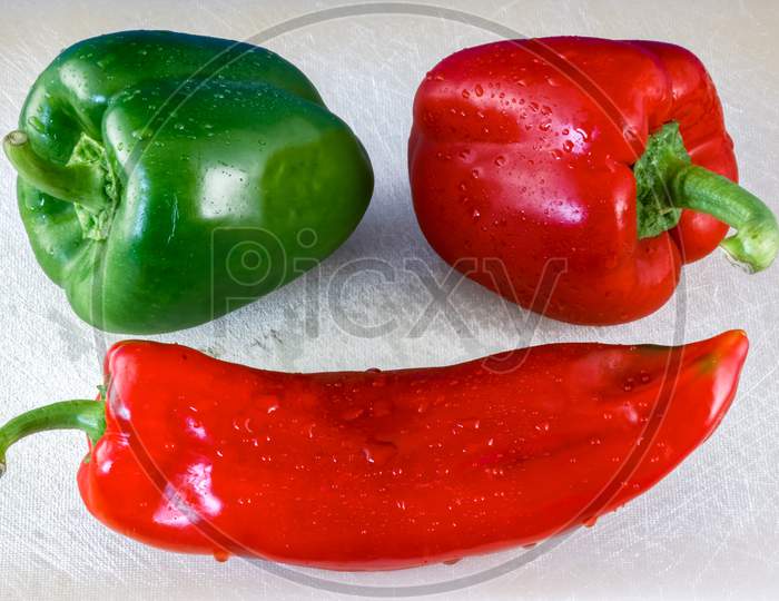 Red And Green Capiscums And A Cayenne Pepper