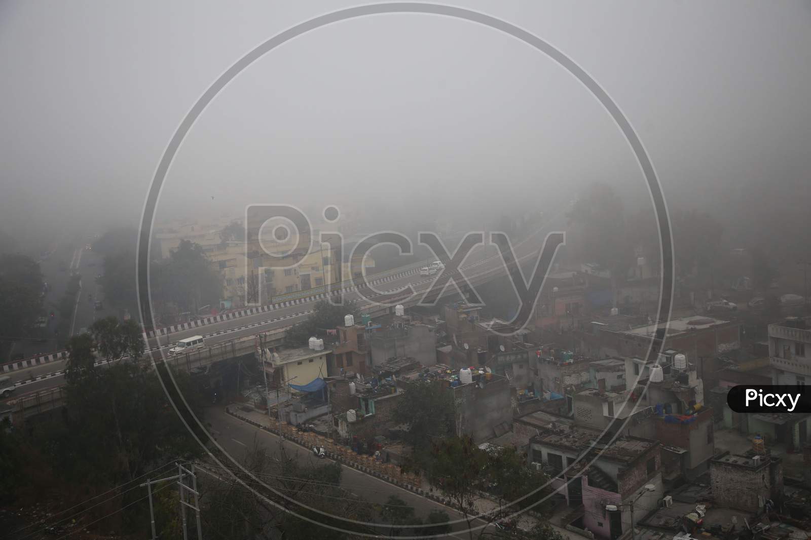 Vehicles Ply On A Road Amid Heavy Fog In Jammu,16,Jan,2021.