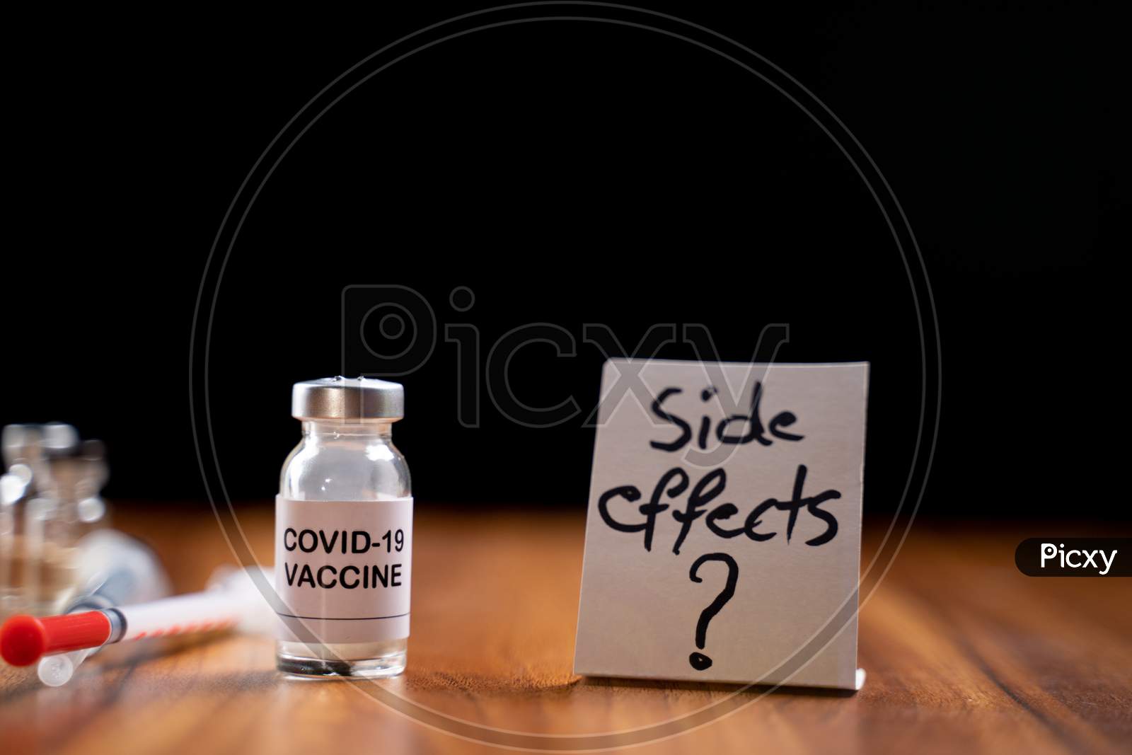 Concept Of Coronavirus Covid-19 Vaccination Side Effects Doubts And Questions Showing With Vaccine Bottle.