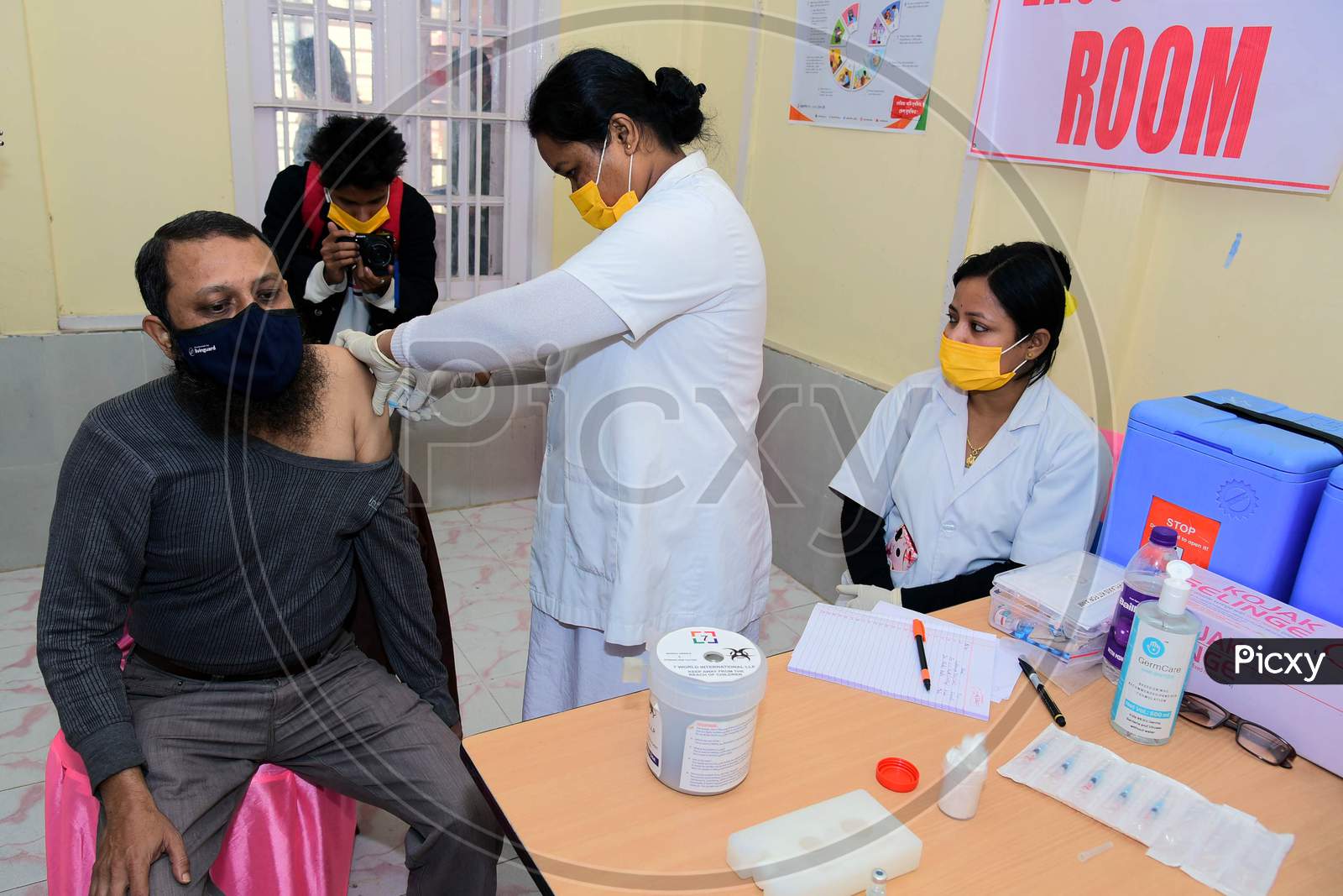 A Nurse administers the Covid-19 Vaccine to a frontline worker, after the virtual launch of Covid-19 Vaccination drive by Prime Minister Narendra Modi, at B.P bivil Hospital In Nagaon District Of Assam on Jan 16,2021.