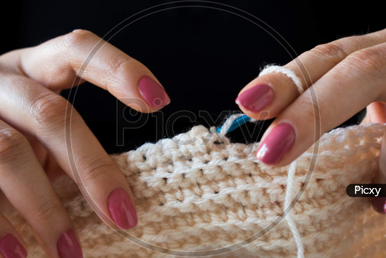 The Woman Knits Woolen Clothes. Knitting Needles.