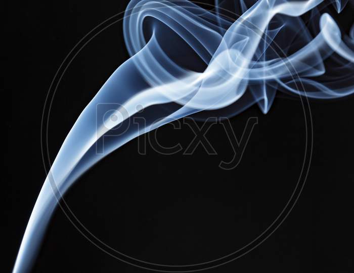 Incense Stick Smoke Trail Against A Black Background