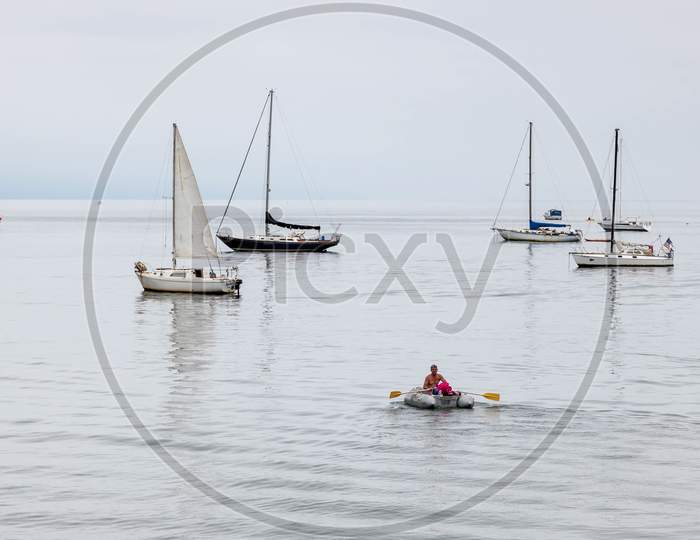 Man Rowing Dinghy Off Santa Barbara Beach