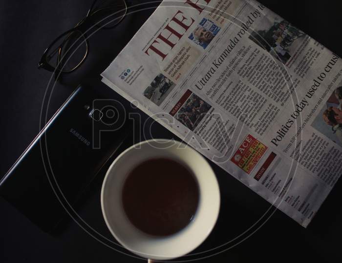 Tea with morning newspaper.