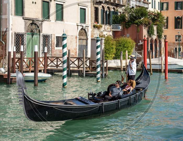 Gondolier Ferrying People In Venice