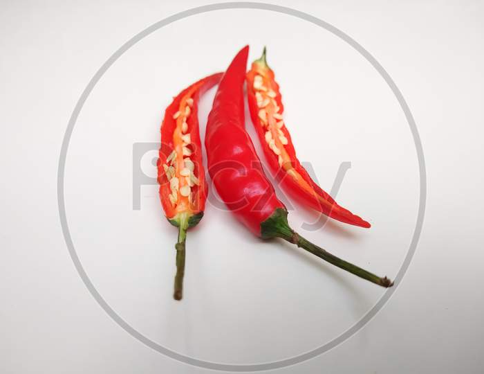 Spicy red chilli peppers isolated on white background