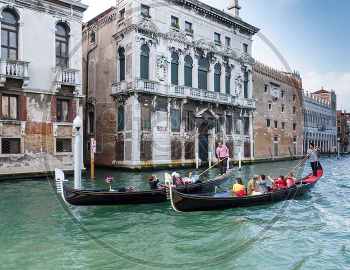 Gondoliers Ferrying People In Venice