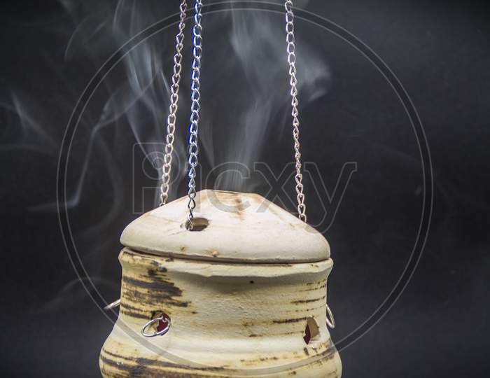 Handmade Incense Bowl Hanging With Smoke Isolated On Black Background