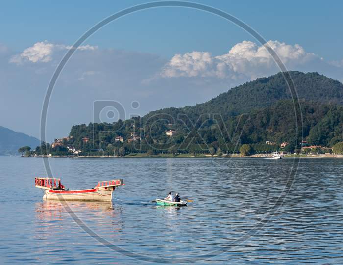 Rowing Boat Pulling A Traditional Boat On Lake Maggiore Piedmont Italy
