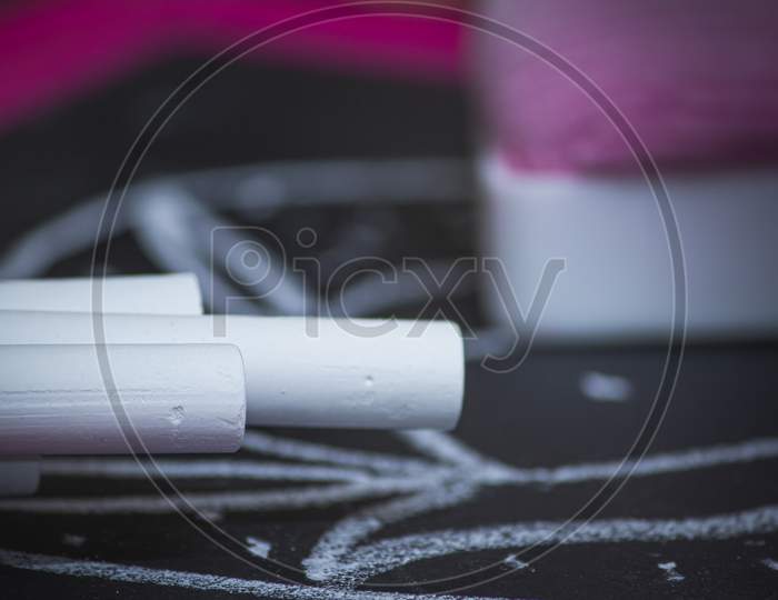 White Chalks Along With The Slate And Duster. Selective Focus. Focus Set On First Chalk