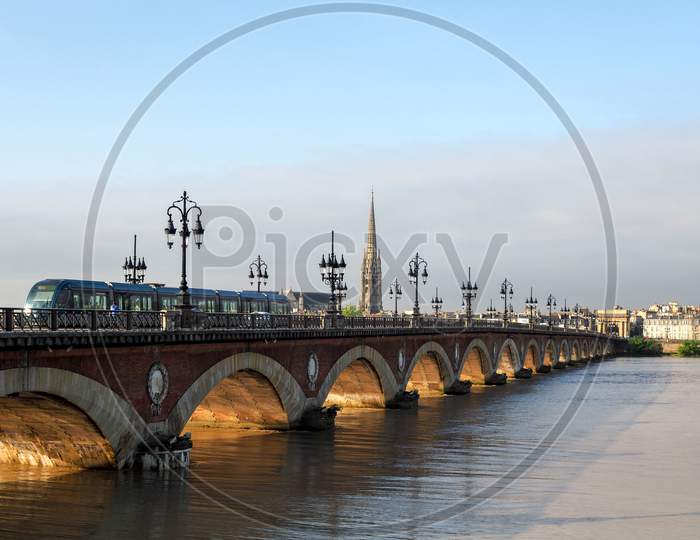 Tram Passing Over The Pont De Pierre Spanning The River Garonne In Bordeaux