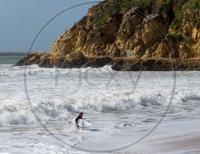 Albufeira, Southern Algarve/Portugal - March 10 : View Of A Surfer At The Beach In Albufeira In Portugal On March 10, 2018. Unidentified Person