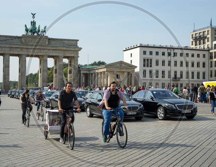 People Cycling Near The Brandenburg Gate In Berlin