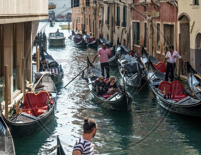 Gondoliers Ferrying Passengers In Venice