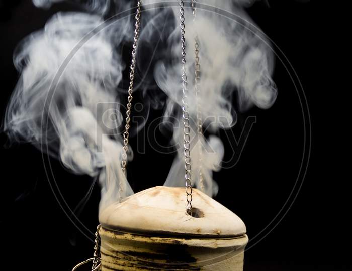 Handmade Incense Bowl Hanging With Smoke Isolated On Black Background