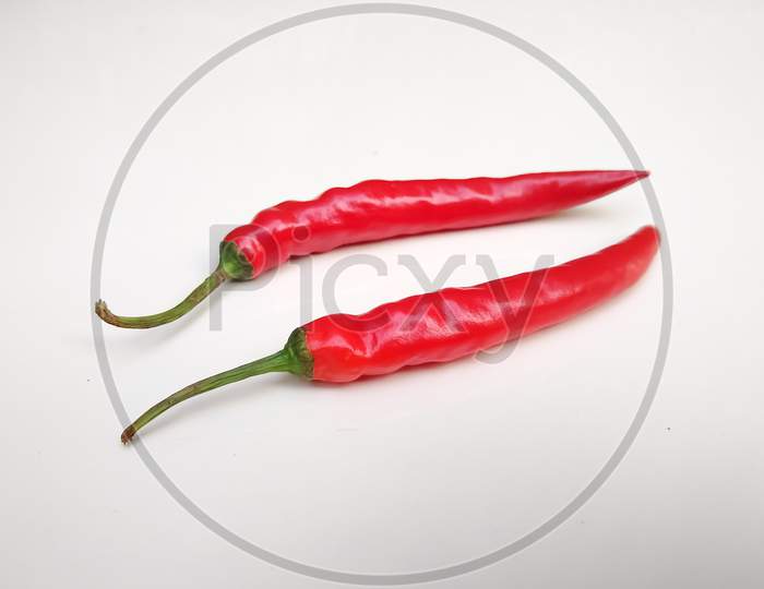 Spicy red chilli peppers isolated on white background