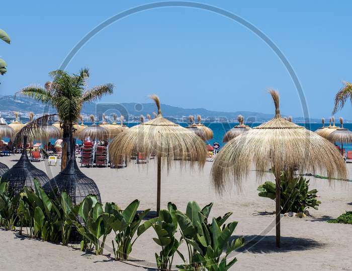 Sun Umbrellas On The Beach At Puerto Banus