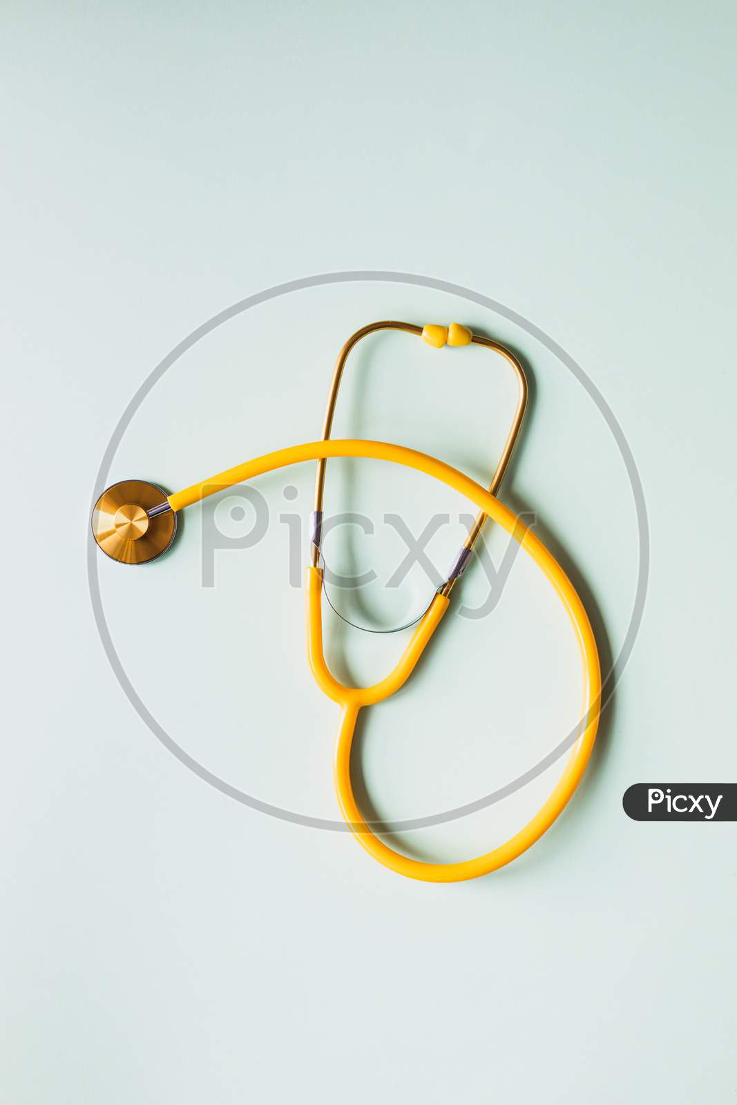 yellow stethoscope on white background