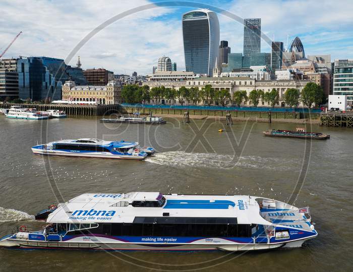 River Buses Cruising Along The River Thames