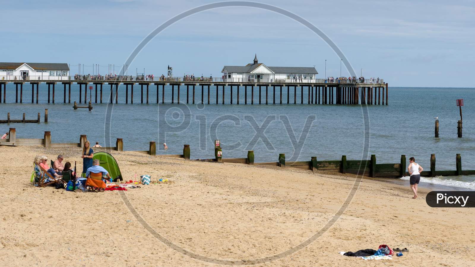 People Enjoying A Sunny Day Out At Southwold