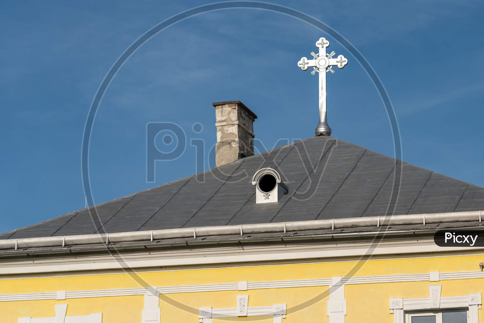 Bistrita, Transylvania/Romania - September 17 : Silver Cross Gleaming In Evening Sunshine On A Building In Bistrita Transylvania Romania On September 17, 2018