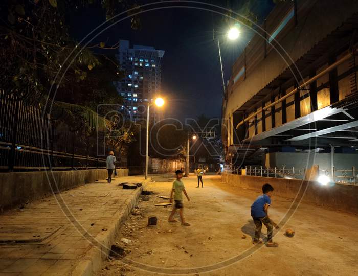 Kids playing under street light of Mumbai city