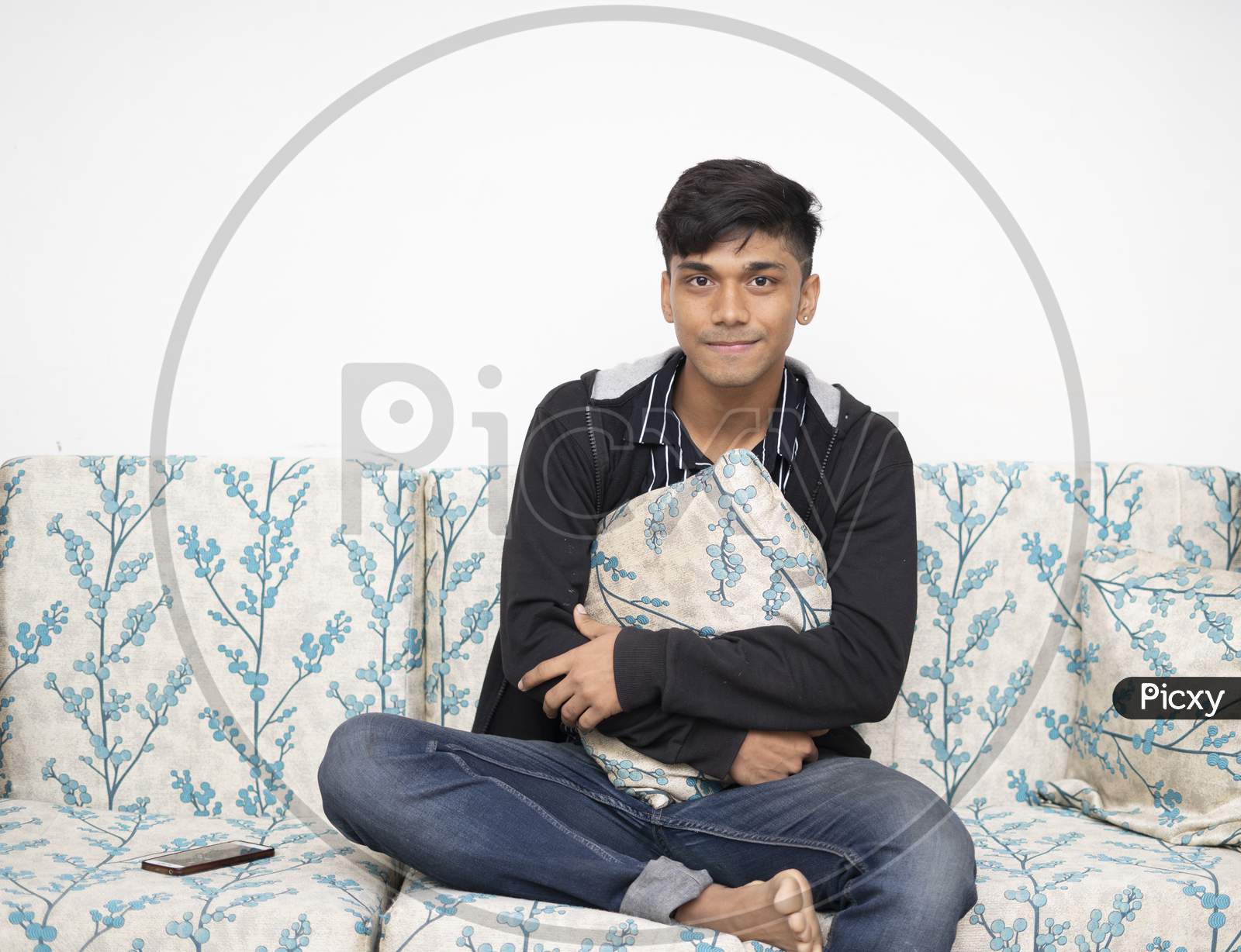 Image of Caucasian Teenager Boy Wearing Jacket, Jeans Holding