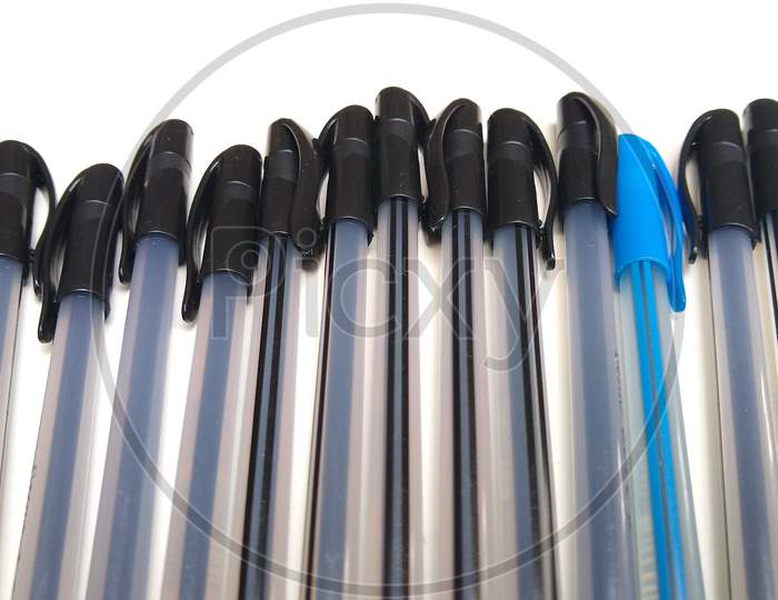 Black and blue pens on white background