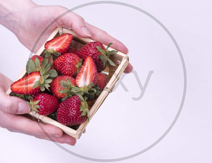Bowl Of Ripe Strawberries In The Girl'S Hands