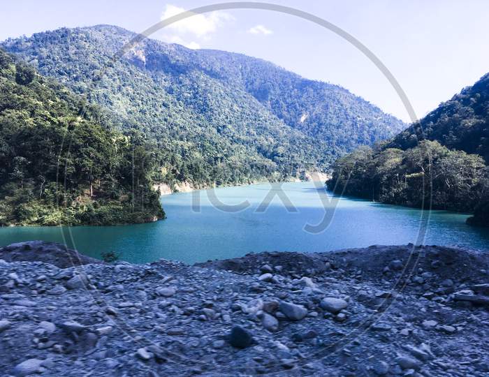 Blue Water Lake And  Mountain  Under Sky Sikkim