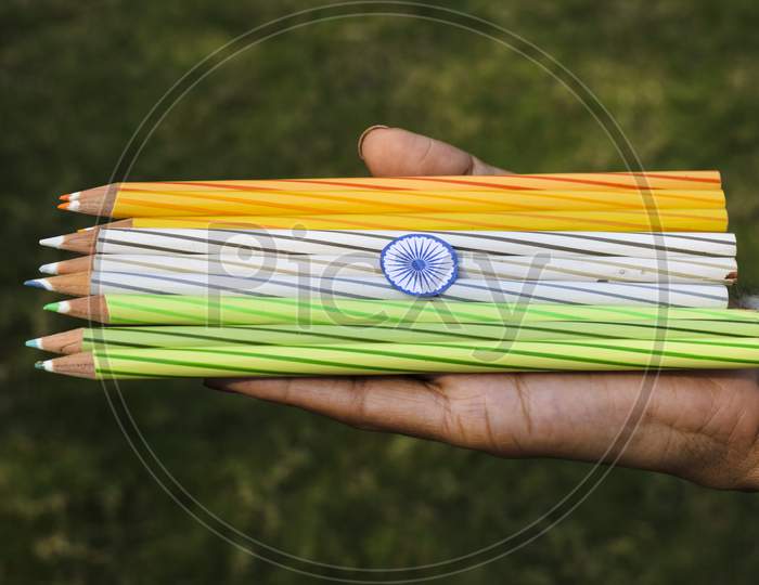 Indian Flag Tricolor Tiranga Saffron, White And Green Embroidery Threads. Female Palms Holding Color Pencils As Concept For Indian Republic Day Celebration Depicting Concept Of Freedom