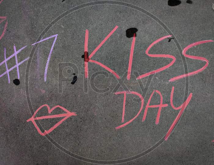 The Inscription Text On The Grey Board, #7 Kiss Day With Hand Drawn Lips Symbol . Using Color Chalk Pieces. Valentines Week