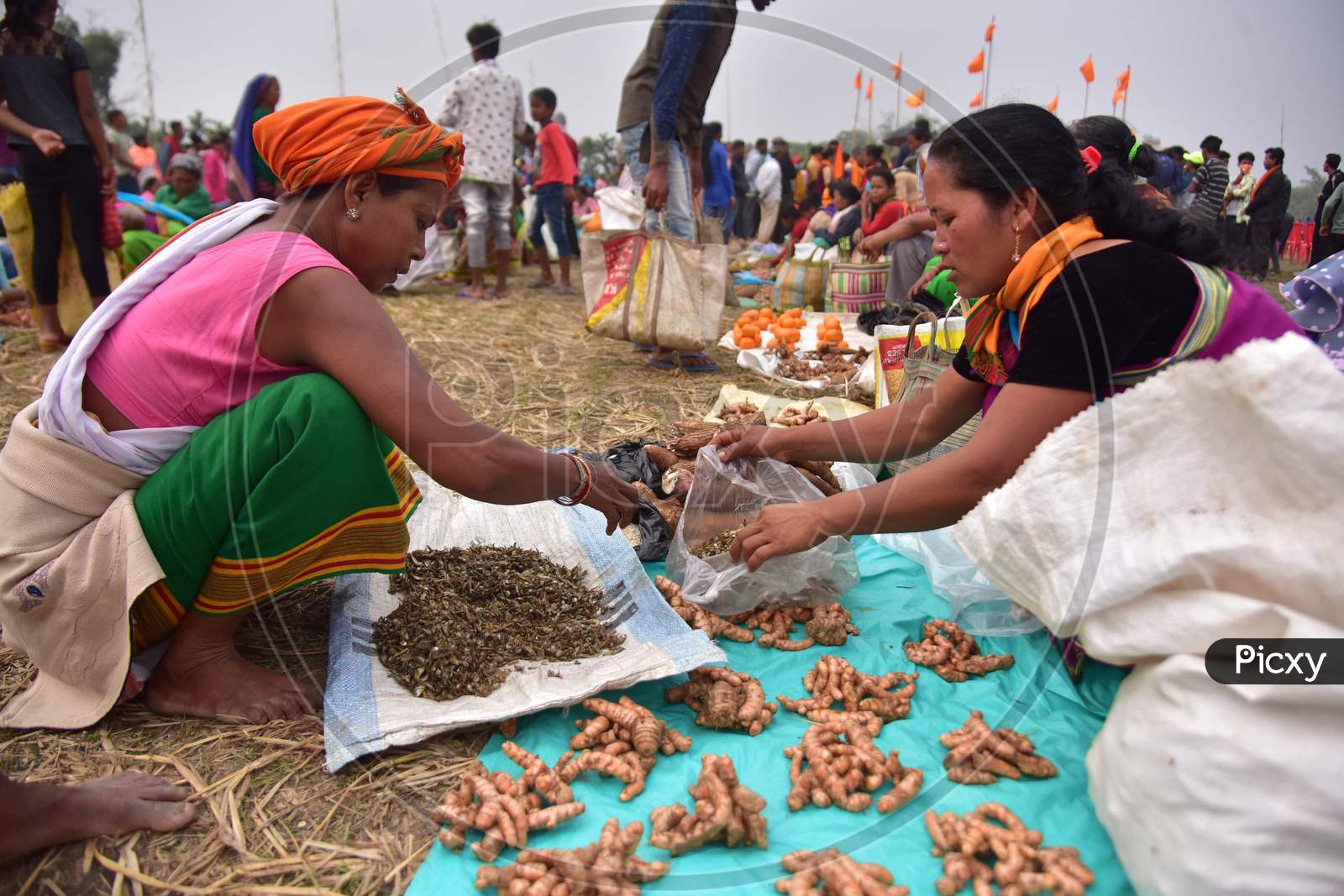 A tribal womane from the Tiwa community exchanges goods in the form of barter system during Udpur festival near Dharamtul in Morigaon District of Assam, India on Jan 19,2021