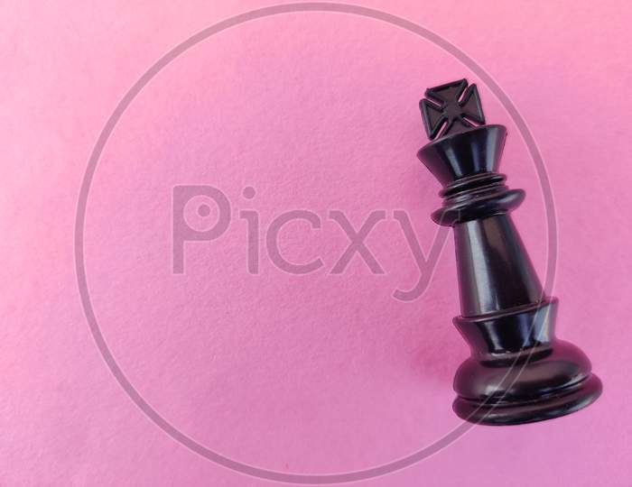 Copy Space Of Black Chess King Isolated On Pink Background.