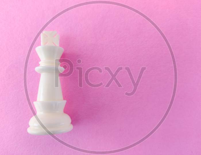 Copy Space Of White Chess King Isolated On Pink Background.