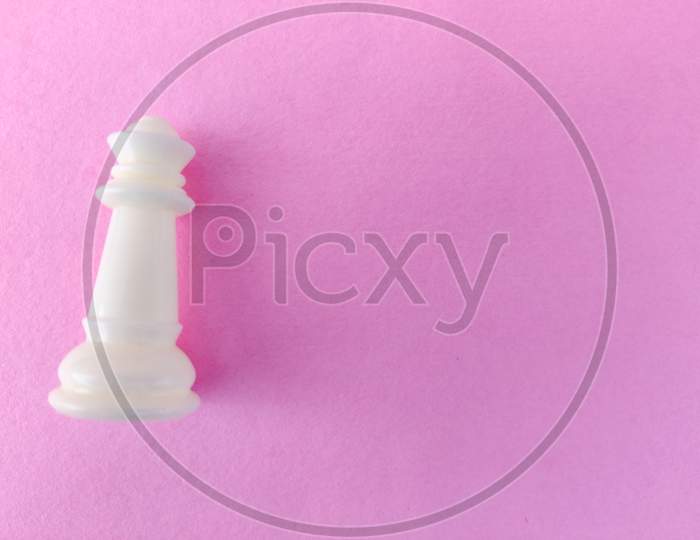 Copy Space Of White Chess Queen Isolated On Pink Background.