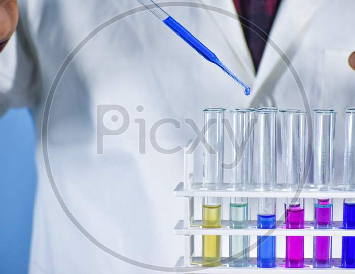 Scientist Taking Color Solution In A Test Tube