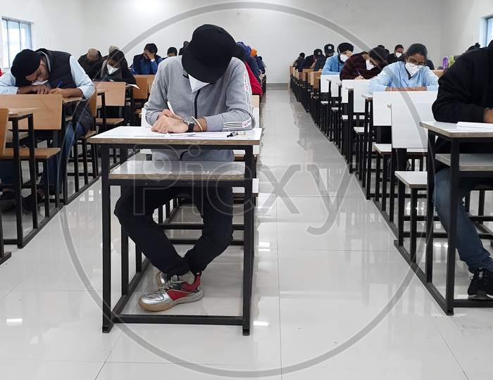 December 8, 2020.Lucknow Uttar Pradesh,India. West Bengal India. Medical Students Writing Examination Paper In Mask Maintaining Social Distancing At Radheshwam Medical College,Lucknow, Up, India