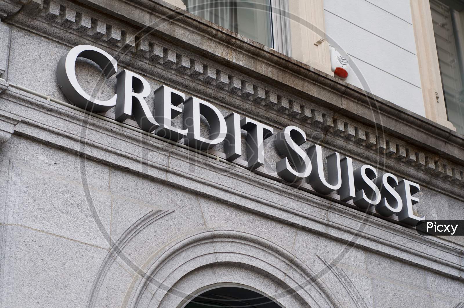 Credit Suisse Bank Sign Hanging On A Old Building Facade