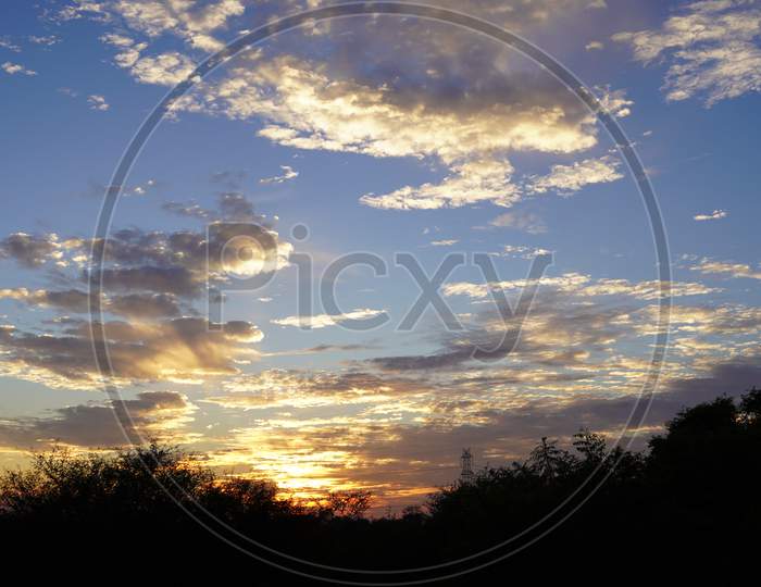 Golden, Yellow, Orange, Pearl And White Clouds At Sunset With Shadow Of Trees. Sunset Landscape.