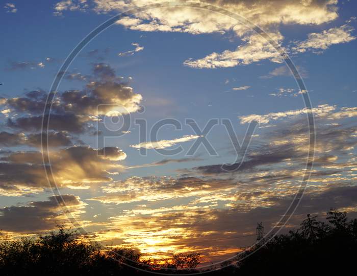 Fiery Golden Sunrise Sky Hovering In Sky. Soft Light Cloudy With Peaceful Nature. Cumulus Wet Clouds Closeup.