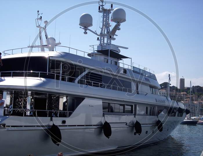 Cannes, France - 07th May 2018: A german photographer visiting the french riviera, taking pictures of the harbor of Cannes with its expensive yachts.