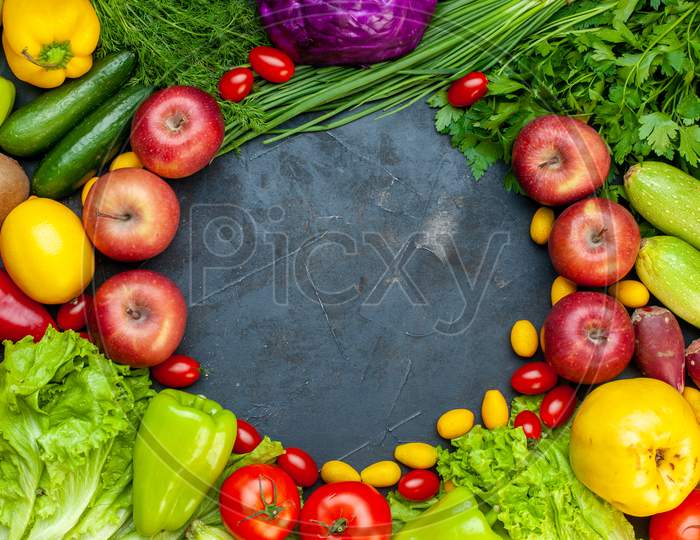 Top View Vegetables And Fruits Lettuce Tomatoes Cucumber Dill Cherry Tomatoes Zucchini Green Onion Parsley Apple Lemon Kiwi Free Space In Center