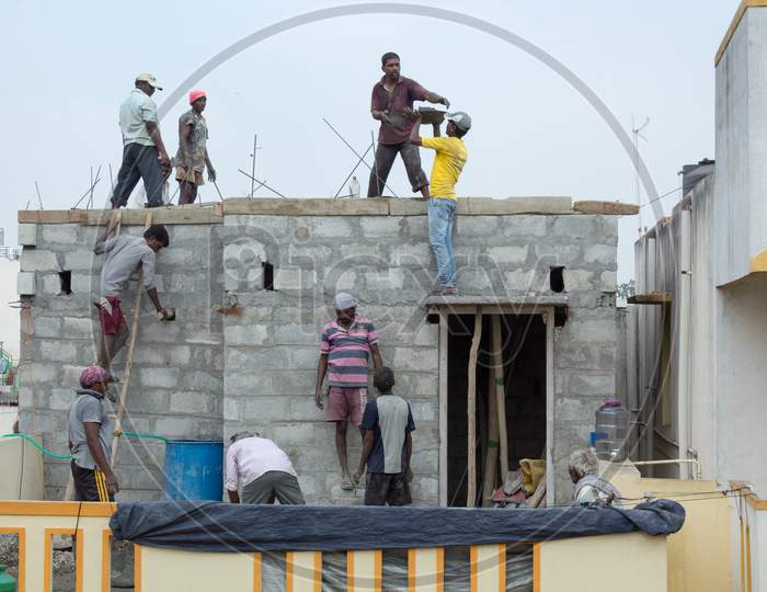 A Civil concrete roofing work in progress during midday on a second floor building construction site in Mysuru,India.