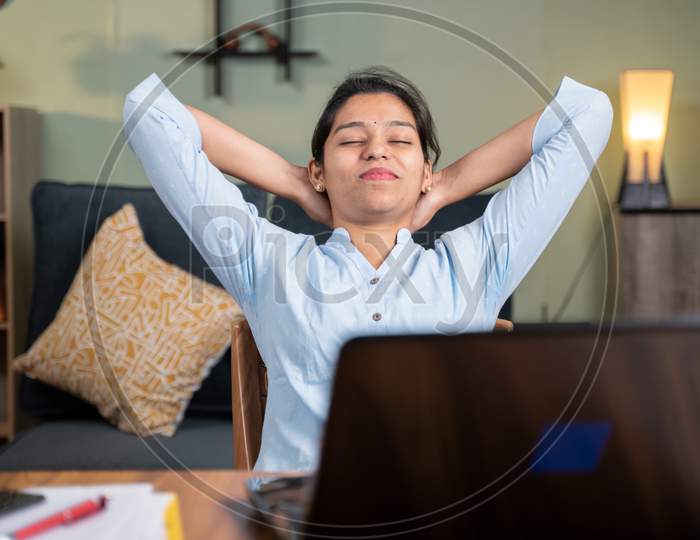 Young Business Woman Feeling Relief After Completion Of Work By Holding Hands Behind Head With Smile - Concept Of Peace, Break, Relaxation Or Satisfaction Of Finishing Work.
