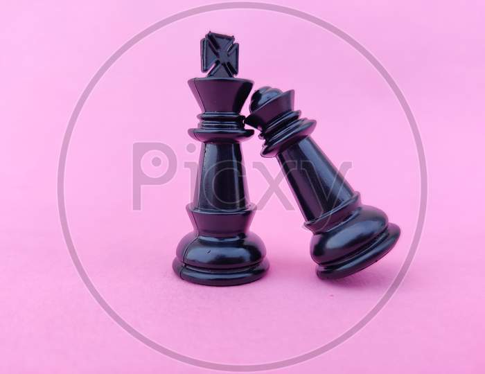 Black Chess Queen Fallen On Black Chess King'S Shoulder. Valentines Day Concept