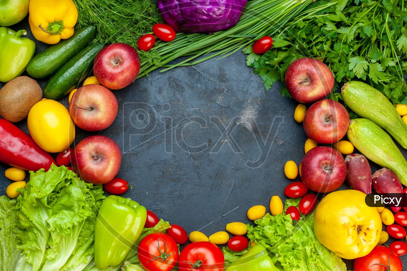 Top View Vegetables And Fruits Lettuce Tomatoes Cucumber Dill Cherry Tomatoes Zucchini Green Onion Parsley Apple Lemon Kiwi Free Space In Center