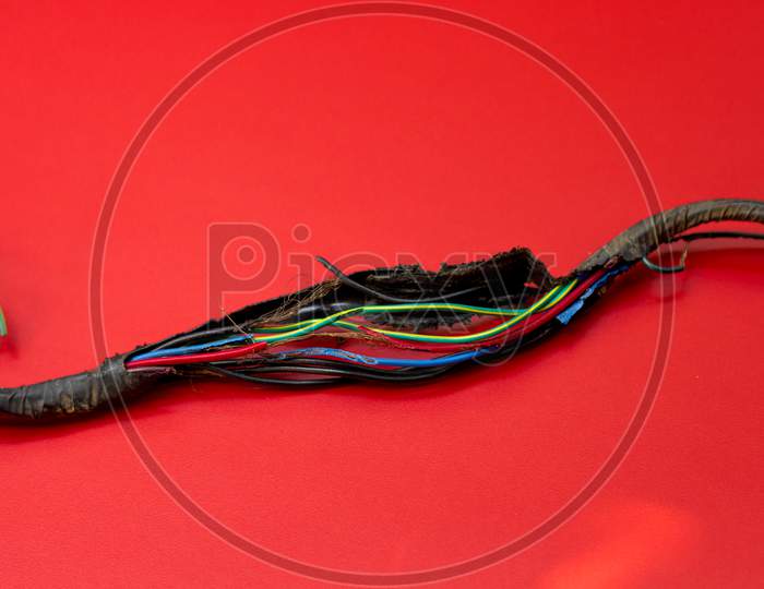 A Picture of a damaged Electrical wiring Harness of a Motor vehicle which has been bitten and  eaten by the rodents.