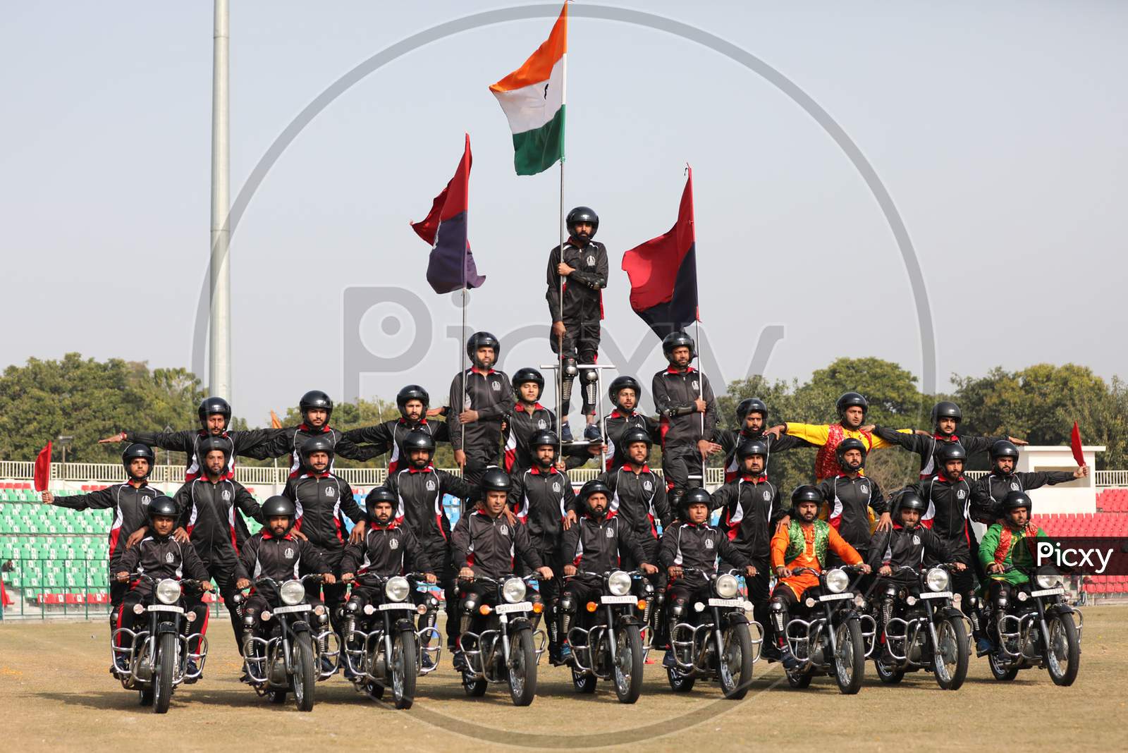 A Jammu and Kashmir policeman performs stunt on a motorcycle during the full dress rehearsal for the Republic Day celebrations, in Jammu, Sunday, Jan. 24, 2021.